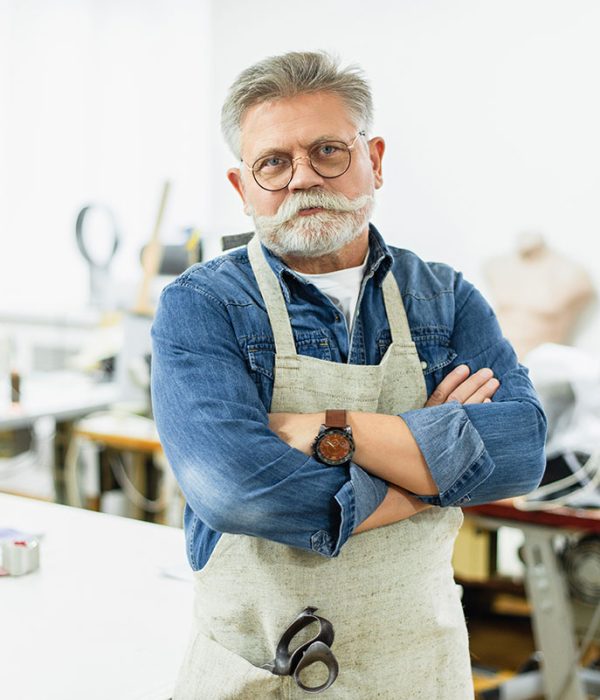 serious-mature-male-craftsman-in-apron-posing-with-resize.jpg